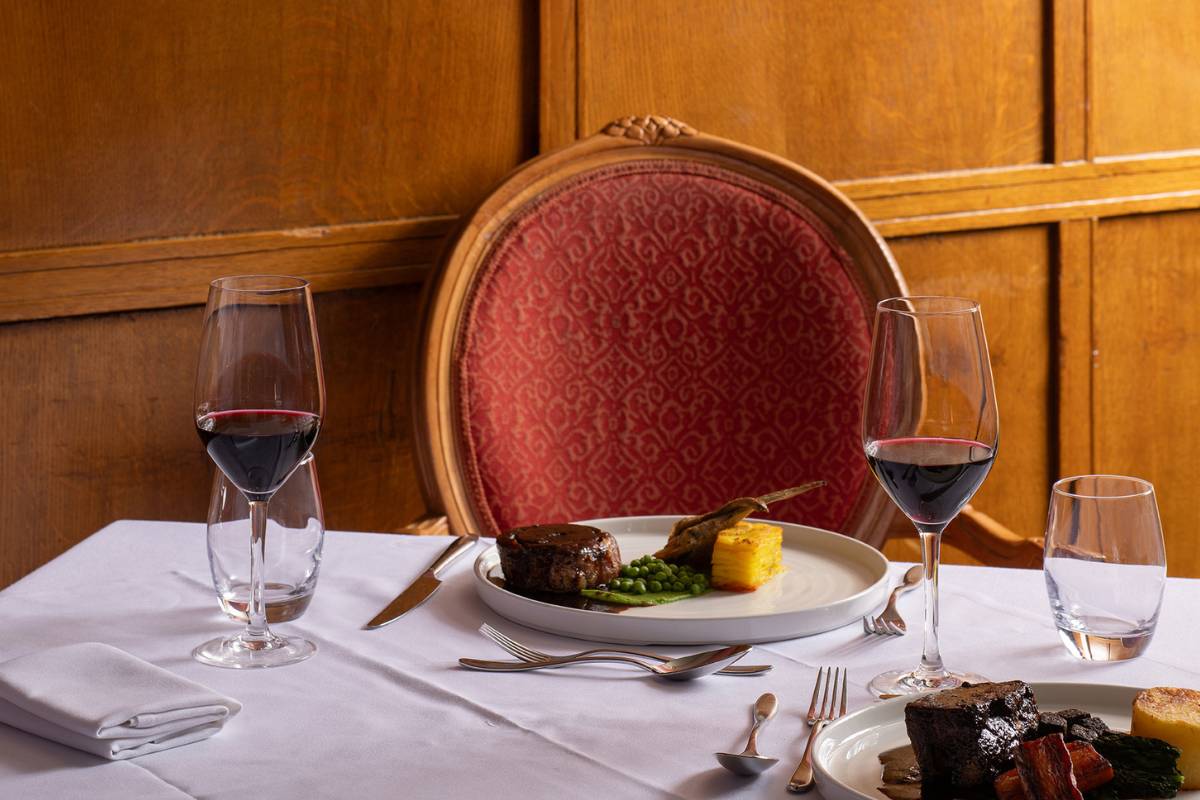 Table laid with a meal and red wine at Chantrey's Restaurant in The Imperial Hotel Llandudno
