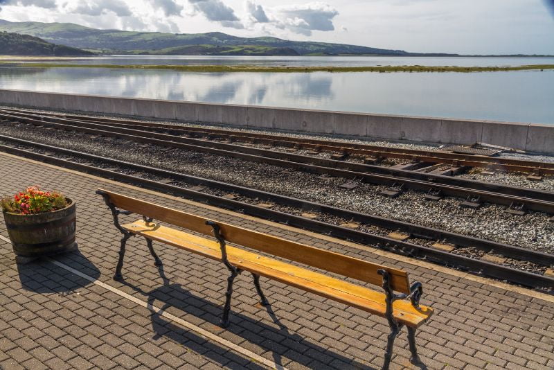 Ffestiniog Railway track in Wales with stunning views of the sea and rolling hills
